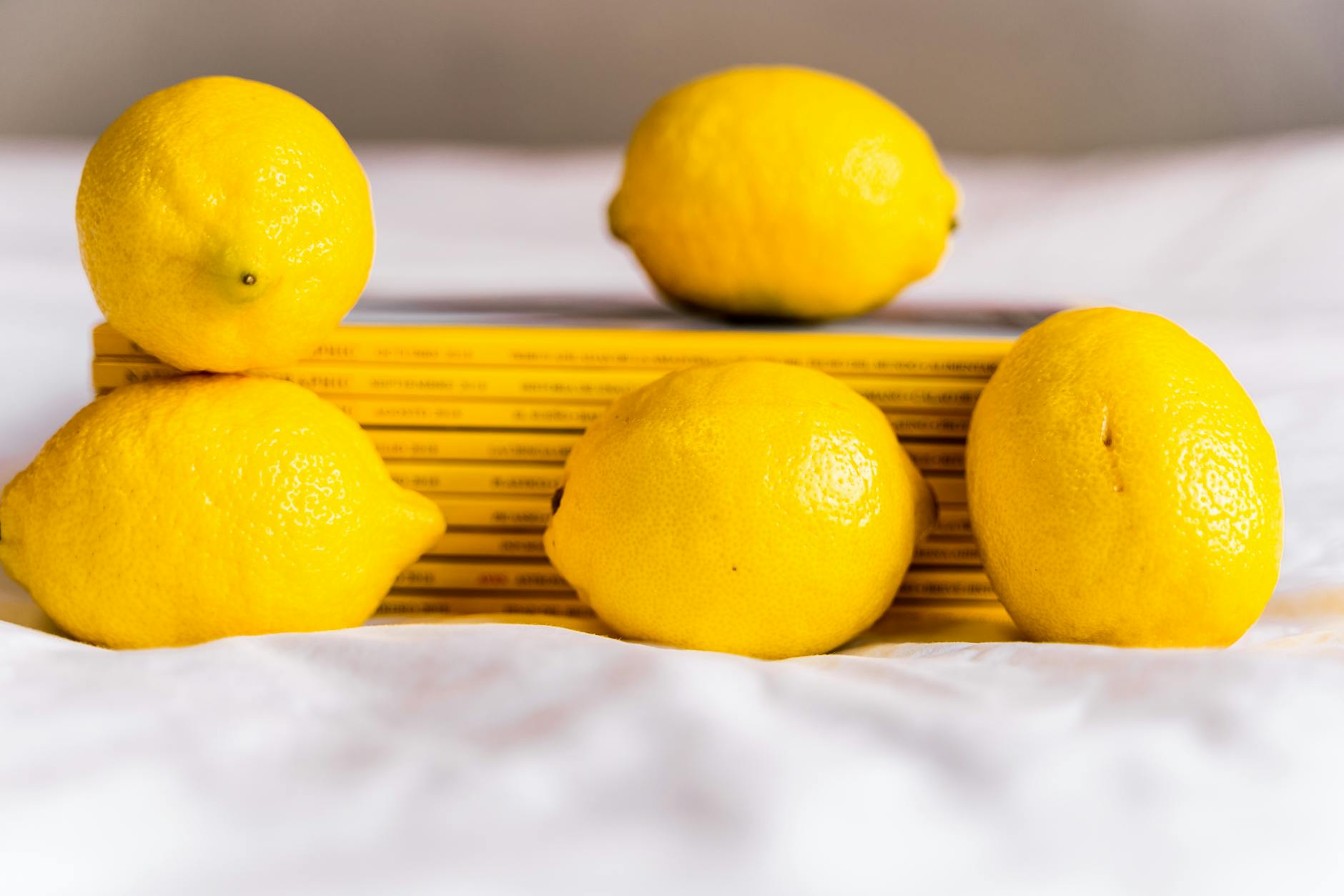 Fresh lemons arranged on white fabric, representing the refreshing intensity of lemon vibrators